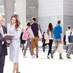 business people in a professional setting with two looking at something together