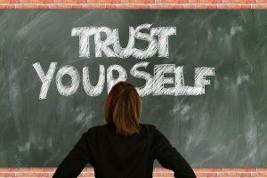 Chalkboard with woman reading Trust Yourself on board